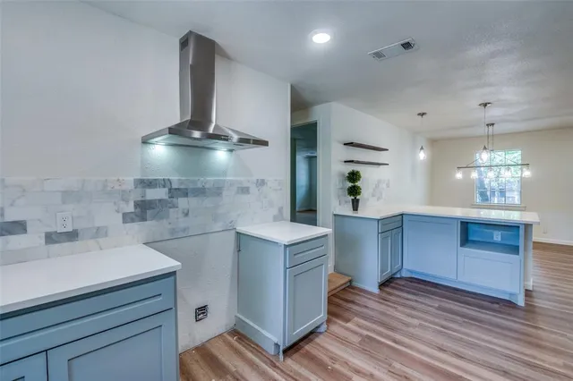 a kitchen with a sink a stove and cabinets