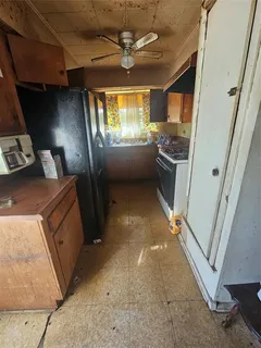 a view of a kitchen with a sink and dishwasher a stove top oven with a dishwasher