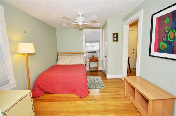526 Centre Street, Unit 5 Boston, MA 02130 - Photo 3 of 14 a bedroom with a bed and wooden floor