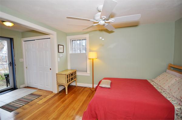 526 Centre Street, Unit 5 Boston, MA 02130 - Photo 7 of 14 a bedroom with a bed and wooden floor