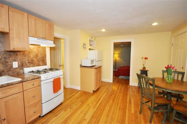 526 Centre Street, Unit 5 Boston, MA 02130 - Photo 9 of 14 a kitchen with a sink and wooden cabinets