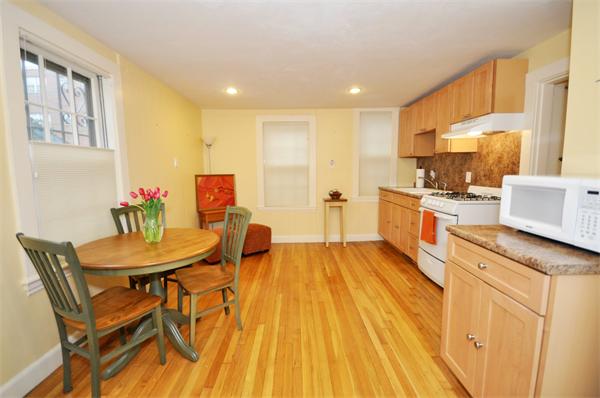 526 Centre Street, Unit 5 Boston, MA 02130 - Photo 10 of 14 a large kitchen with a table and chairs in it