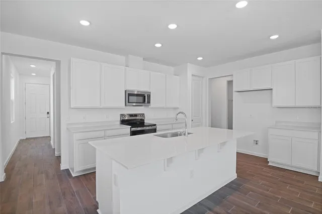 a kitchen with stainless steel appliances a refrigerator sink and cabinets