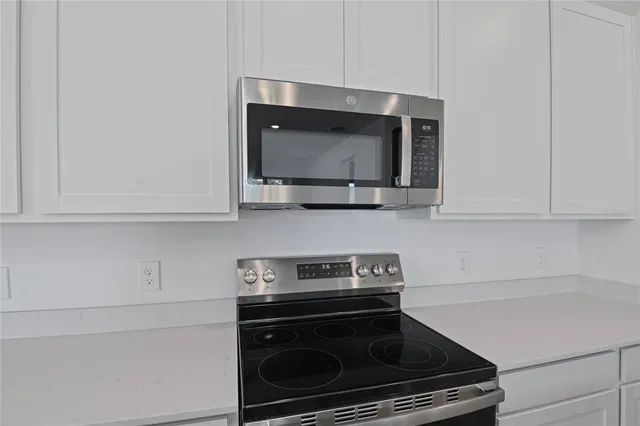 a kitchen with a stove and a microwave