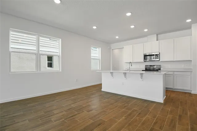 a kitchen with granite countertop white cabinets and white appliances