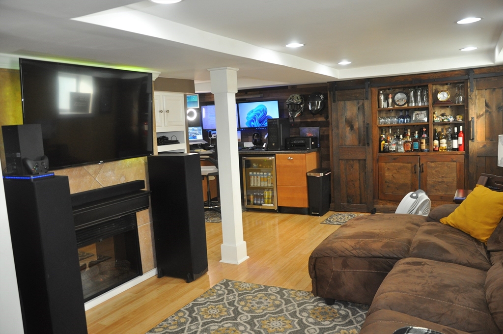 57 Crompton Street Acushnet, MA 02743 - Photo 13 of 21 a living room with furniture a flat screen tv and a refrigerator