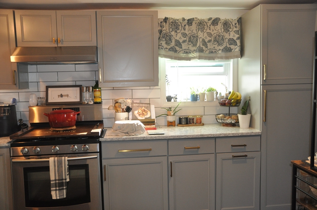 57 Crompton Street Acushnet, MA 02743 - Photo 15 of 21 a kitchen with stainless steel appliances a sink a stove and a window
