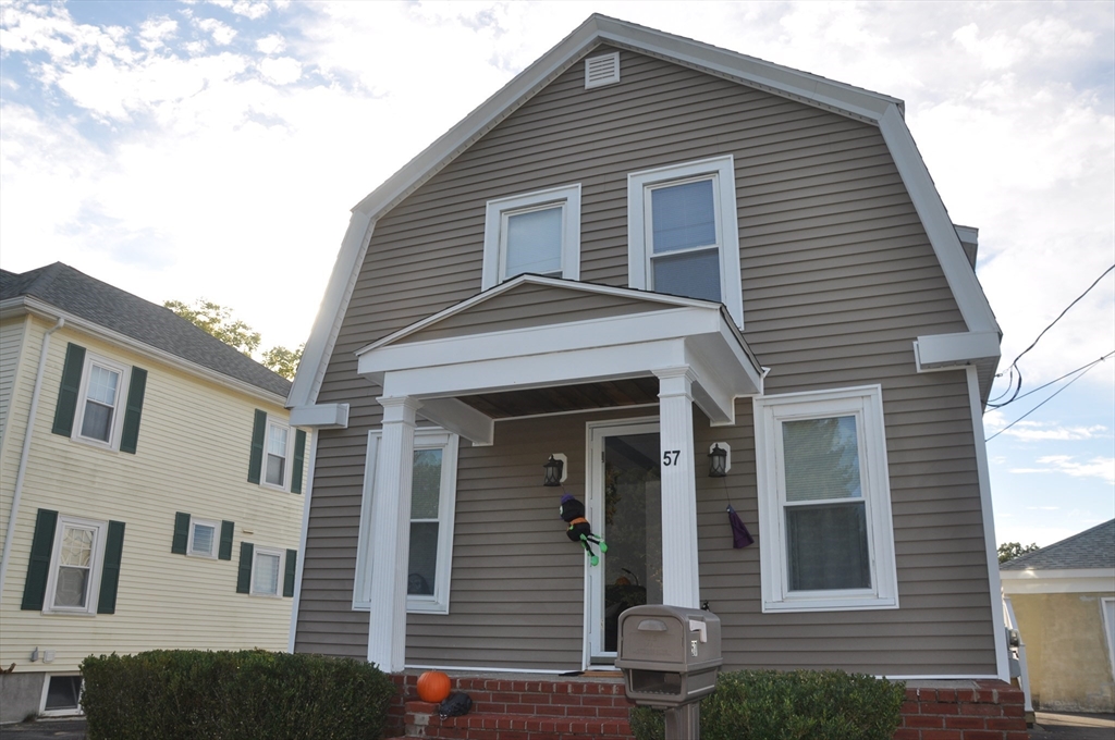 57 Crompton Street Acushnet, MA 02743 - Photo 3 of 21 a front view of a house with a garage