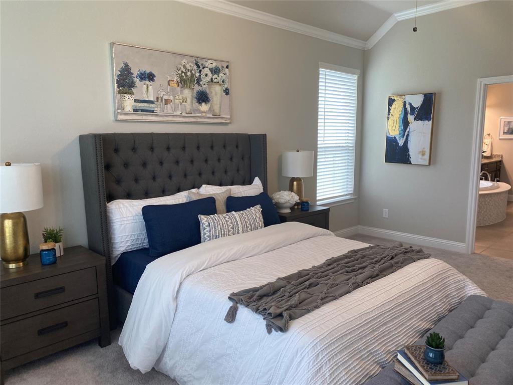209 Johnson Street Granbury, TX 76048 - Photo 23 of 40 Carpeted bedroom featuring vaulted ceiling, ensuite bathroom, and ornamental molding