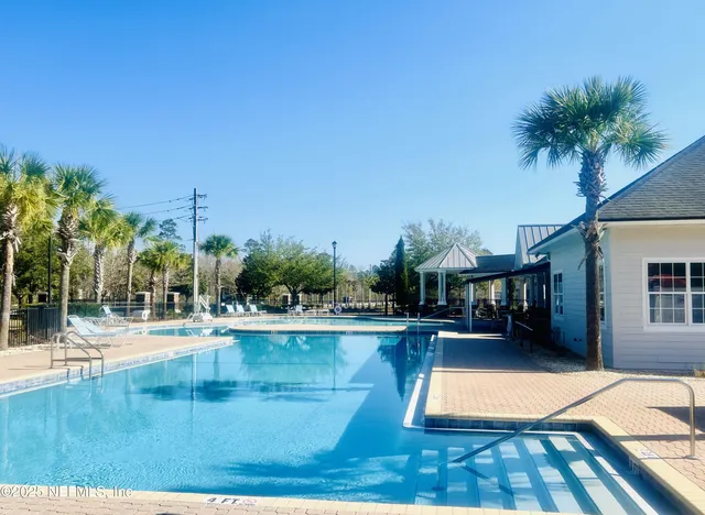 a view of a swimming pool with an outdoor space and seating area