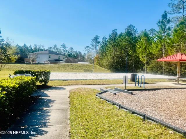 a view of a swimming pool with a table and chairs