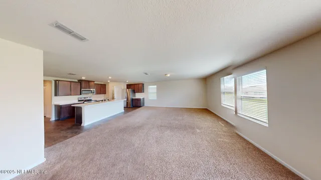a view of a kitchen with a sink and a window