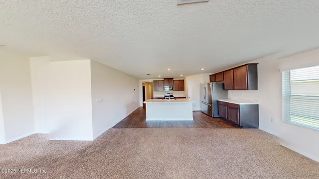 a view of a kitchen with a sink and a window