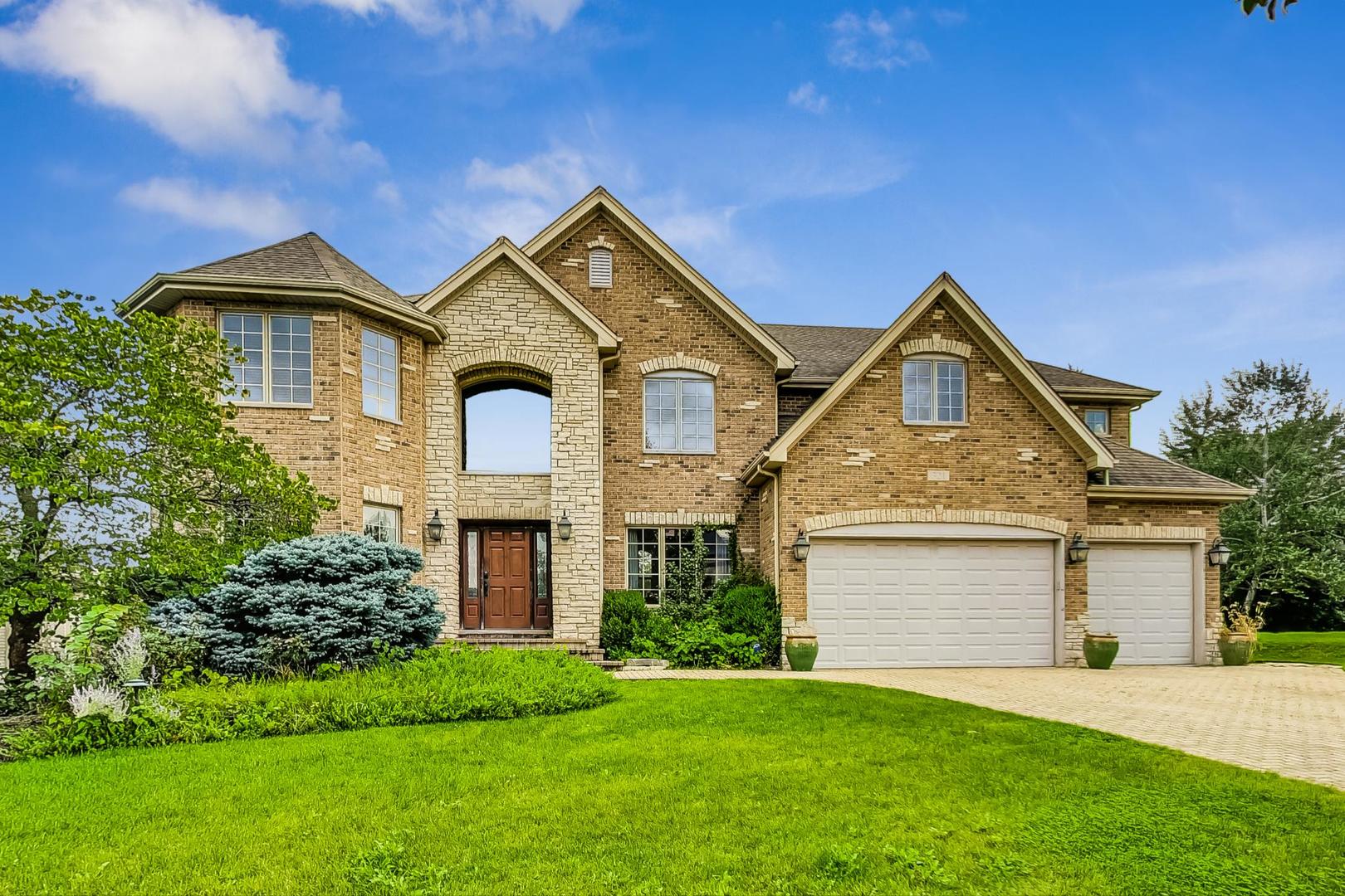 321 Forest Drive Addison, IL 60101 - Photo 1 of 35 a front view of a house with a yard and garage