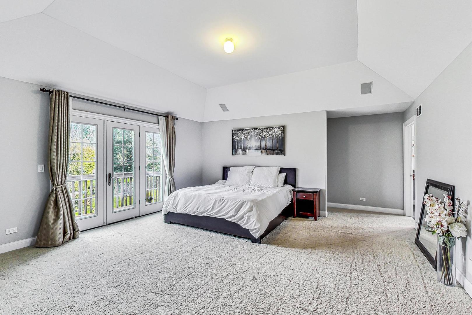 321 Forest Drive Addison, IL 60101 - Photo 14 of 35 a spacious bedroom with a bed and a large window