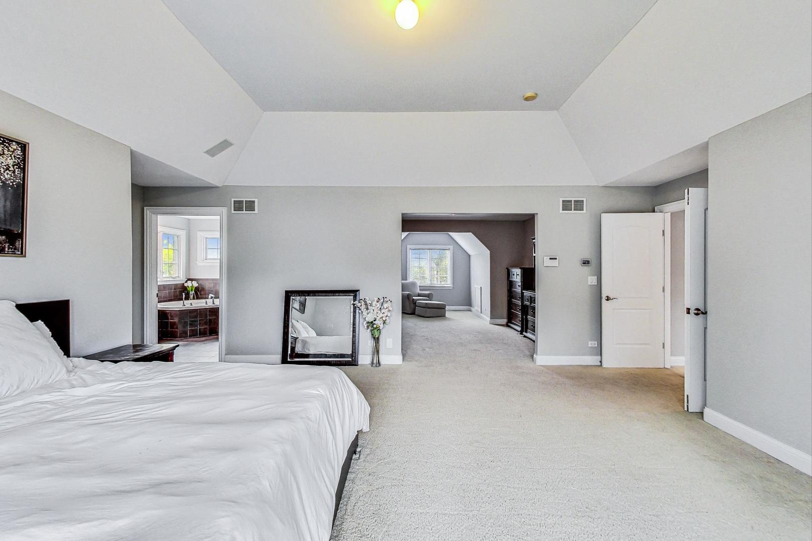 321 Forest Drive Addison, IL 60101 - Photo 15 of 35 a large bedroom with a bed and a large mirror