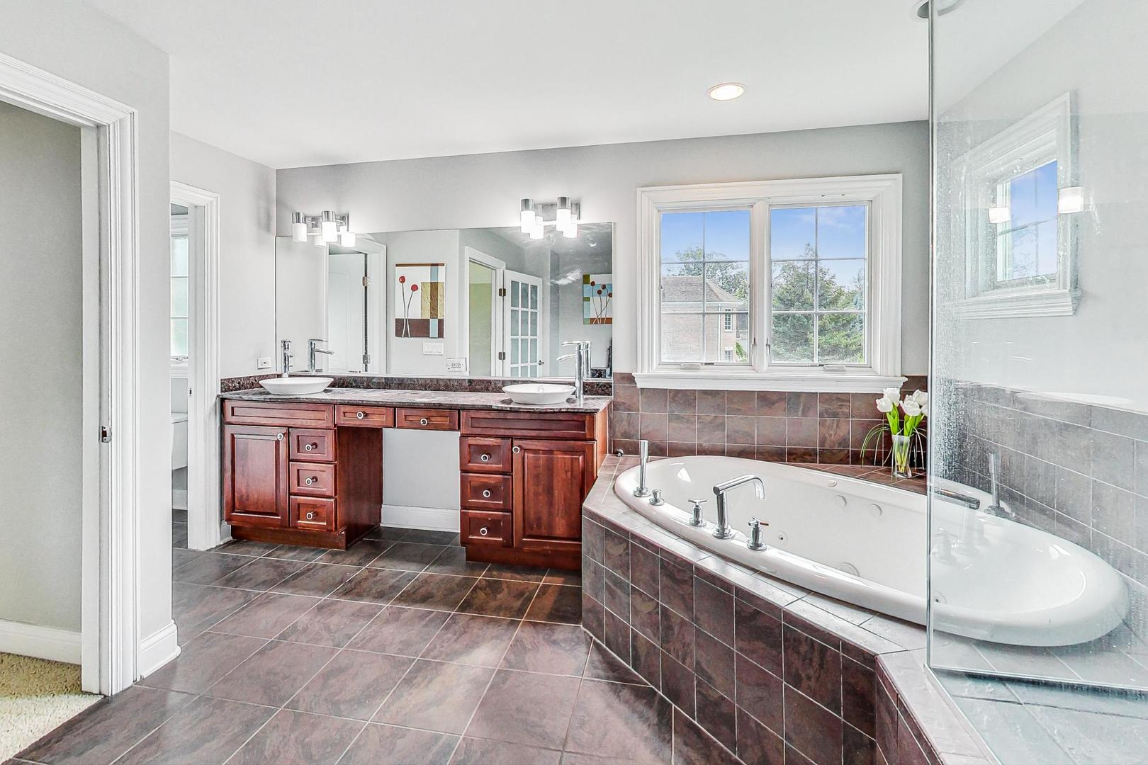 321 Forest Drive Addison, IL 60101 - Photo 17 of 35 a bathroom with a tub a sink and a large window