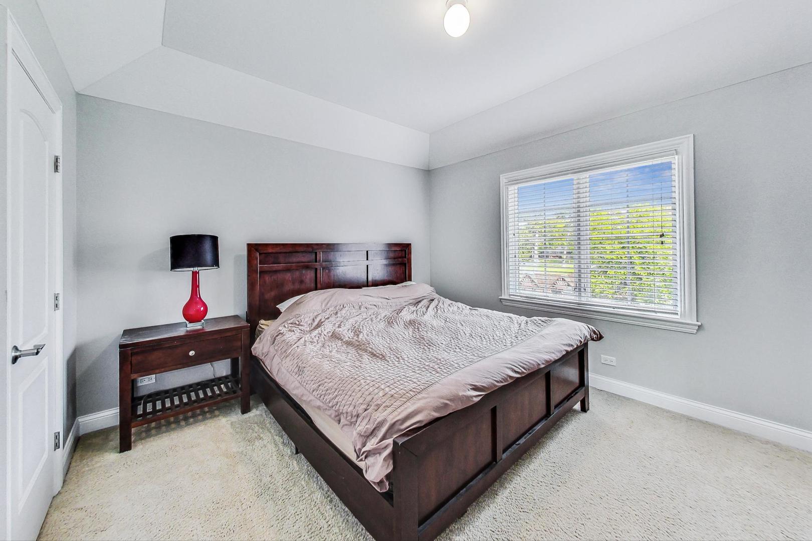 321 Forest Drive Addison, IL 60101 - Photo 20 of 35 a bed sitting in a bedroom next to a window