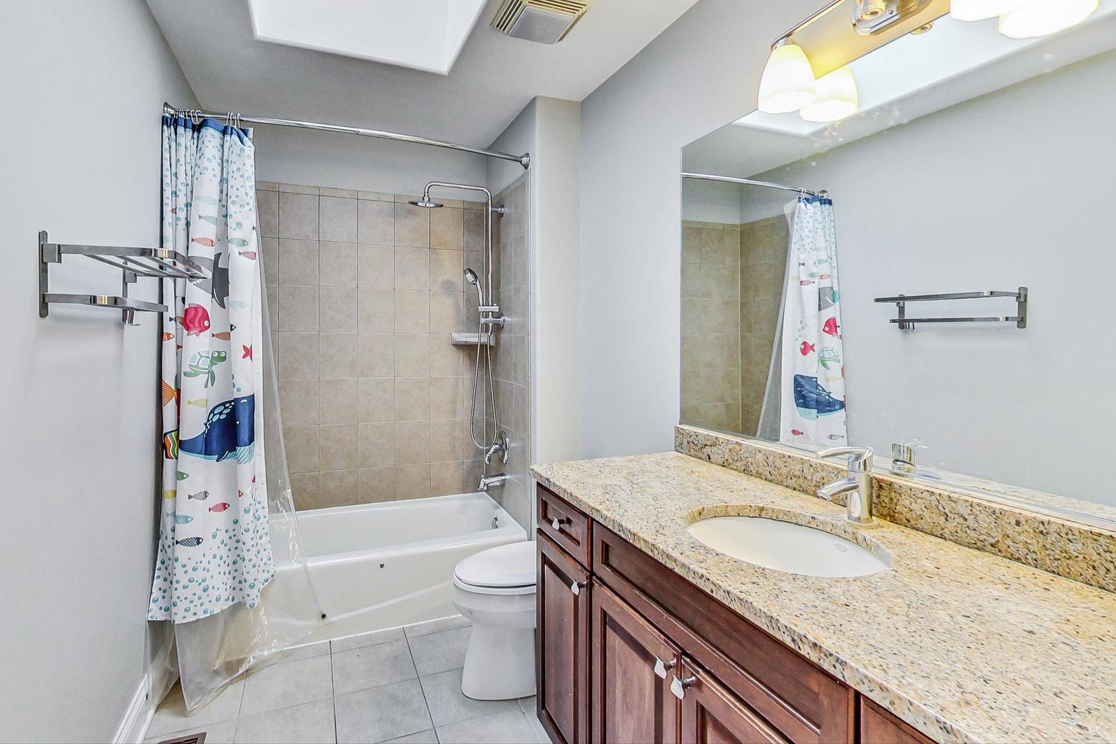 321 Forest Drive Addison, IL 60101 - Photo 22 of 35 a bathroom with a granite countertop sink a toilet and shower