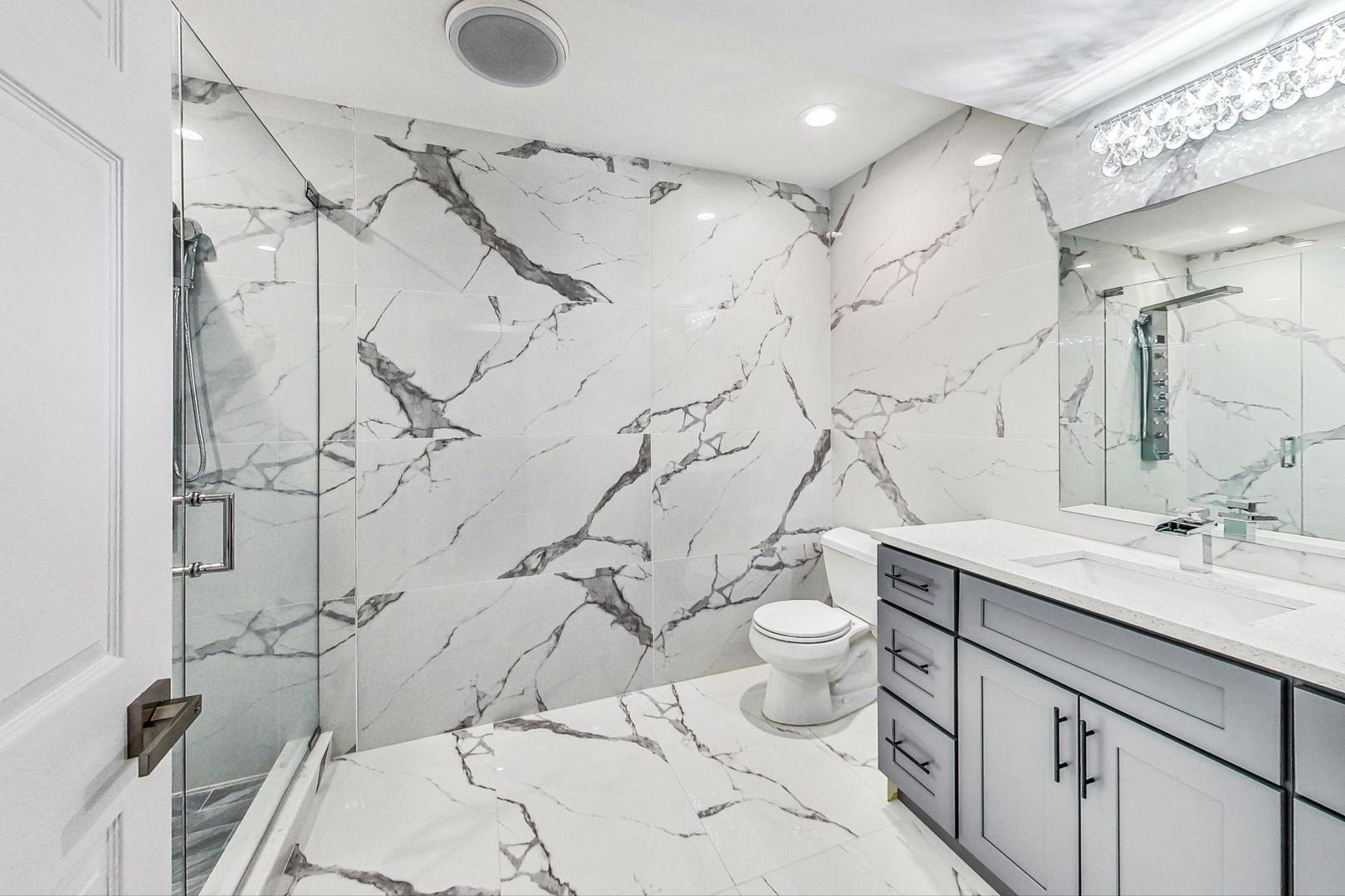 321 Forest Drive Addison, IL 60101 - Photo 28 of 35 a bathroom with a granite countertop sink a toilet and shower