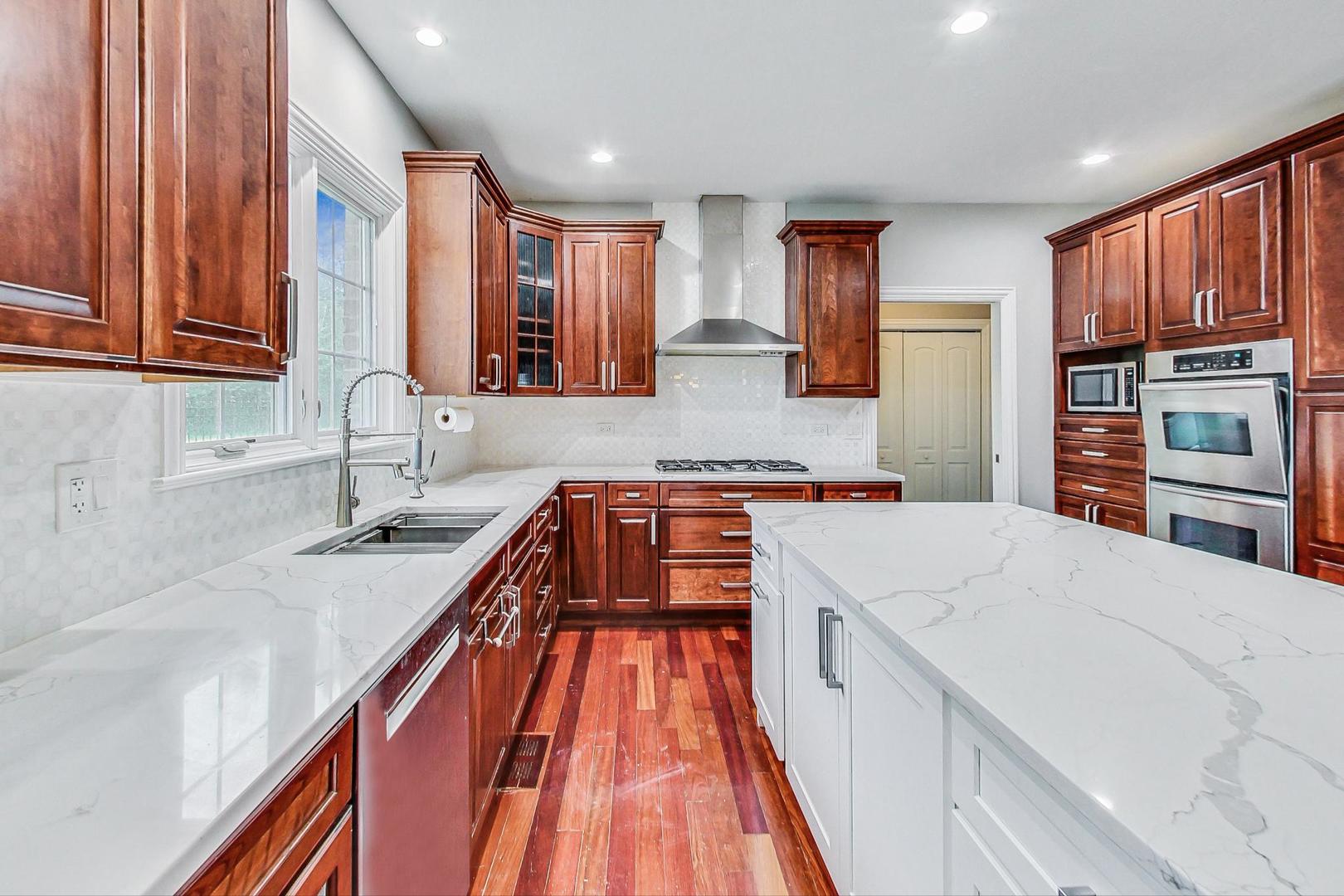 321 Forest Drive Addison, IL 60101 - Photo 4 of 35 a large kitchen with a large counter top a sink a stove and a refrigerator
