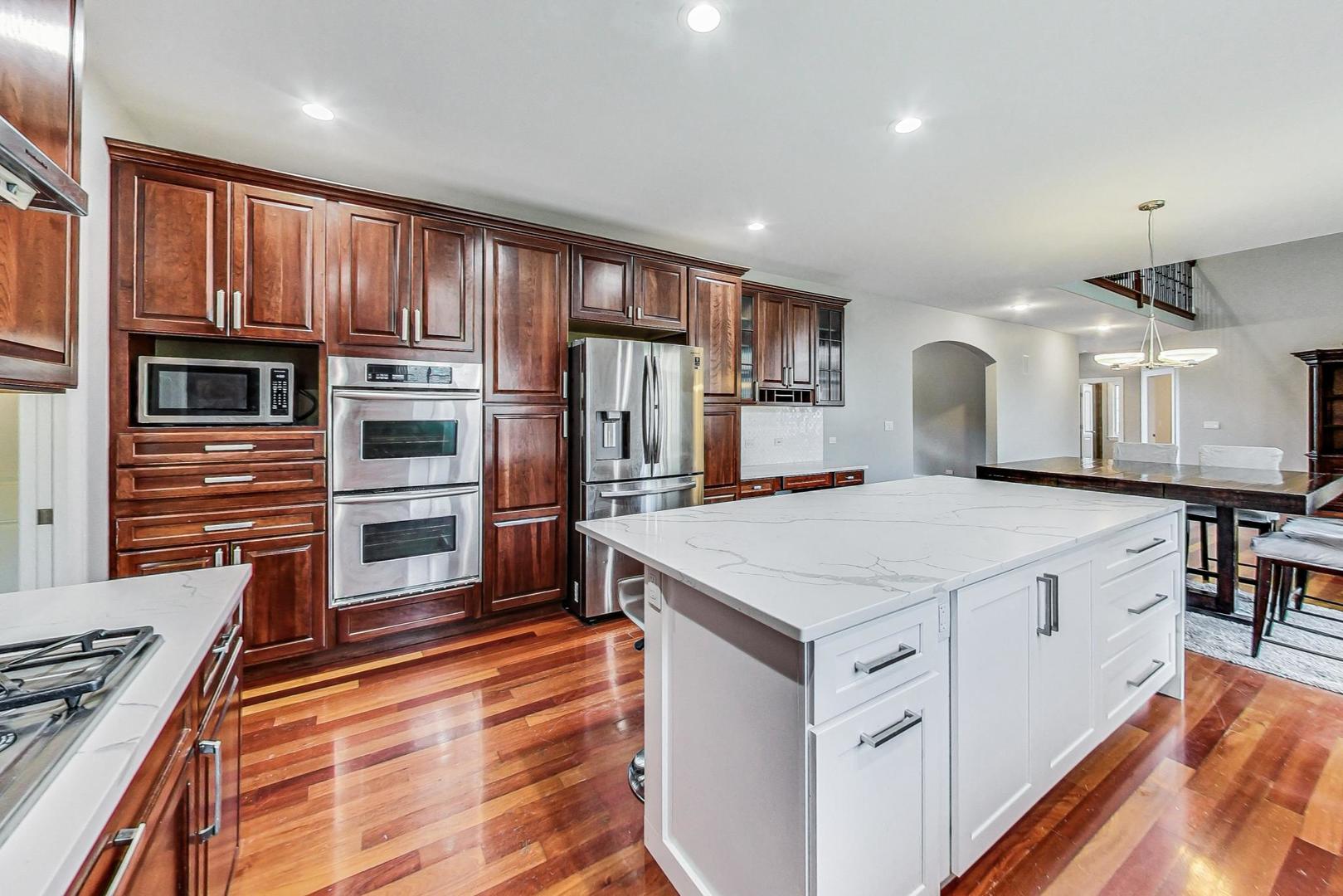 321 Forest Drive Addison, IL 60101 - Photo 5 of 35 a kitchen with stainless steel appliances a stove a refrigerator and a sink