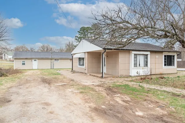 a view of a house with a yard and garage