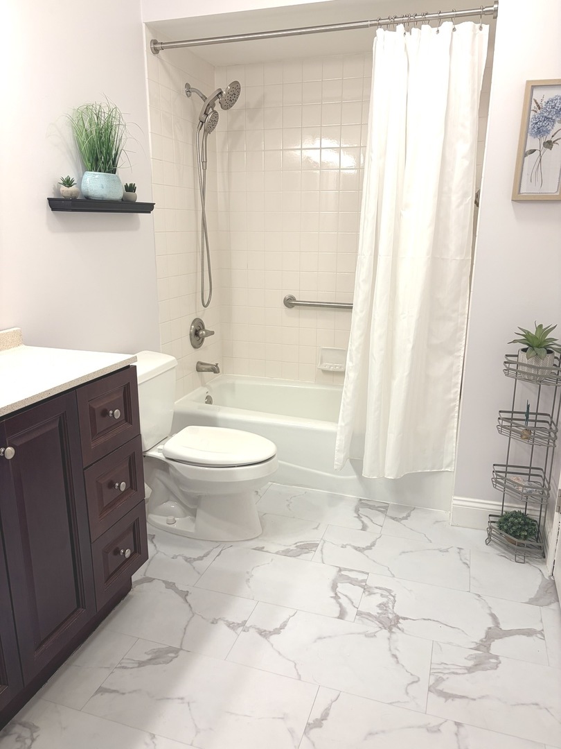 300 East Dundee Road, Unit 102A Buffalo Grove, IL 60089 - Photo 20 of 27 a bathroom with a granite countertop sink toilet and shower