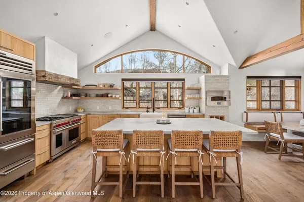 a large kitchen with a table and chairs