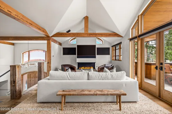 a living room with furniture a fireplace and a large window