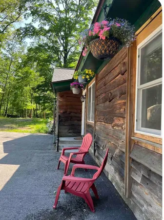 a view of a chairs and table in the back yard of the house