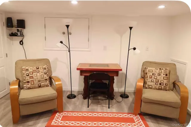 a living room with furniture a rug and a chandelier