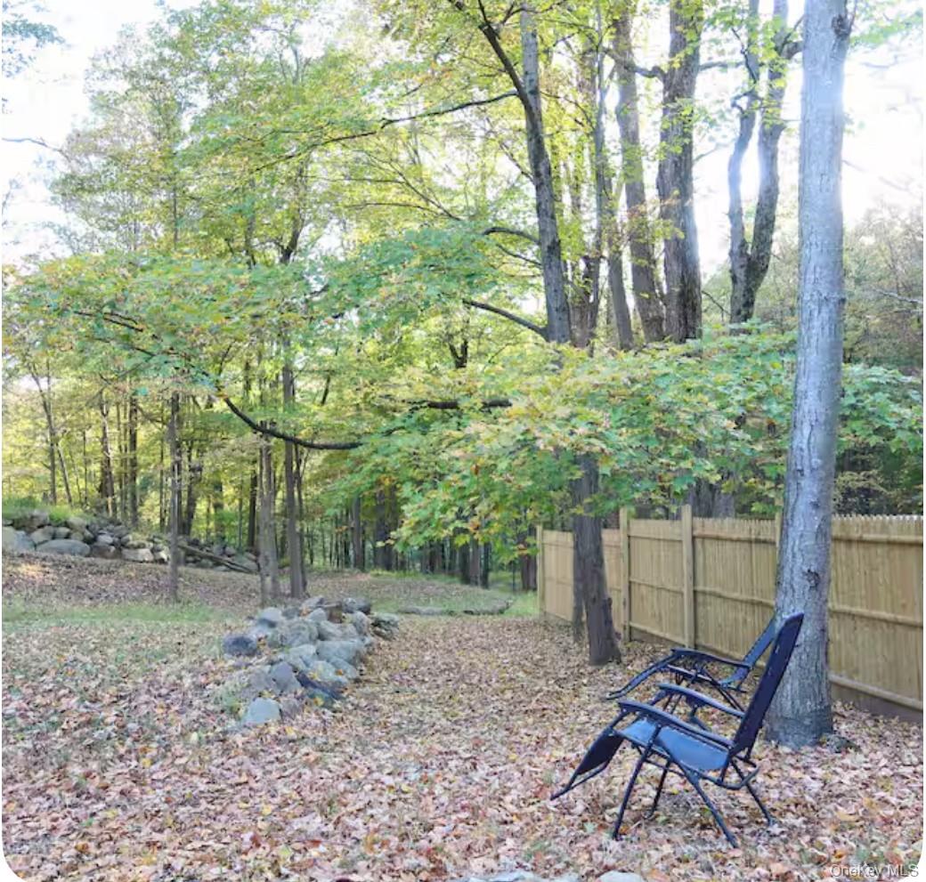 137 Canterbury Road Fort Montgomery, NY 10922 - Photo 18 of 20 a view of a backyard with a bench and chair