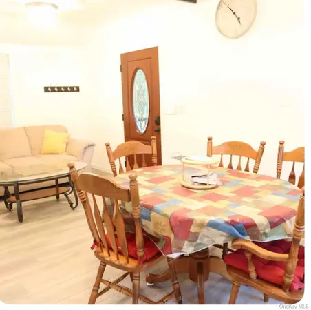 a dining room with furniture and a mirror
