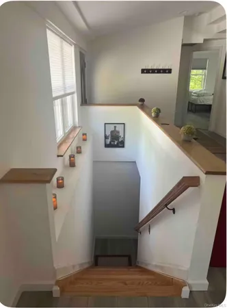 a view of a hallway with windows and stairs
