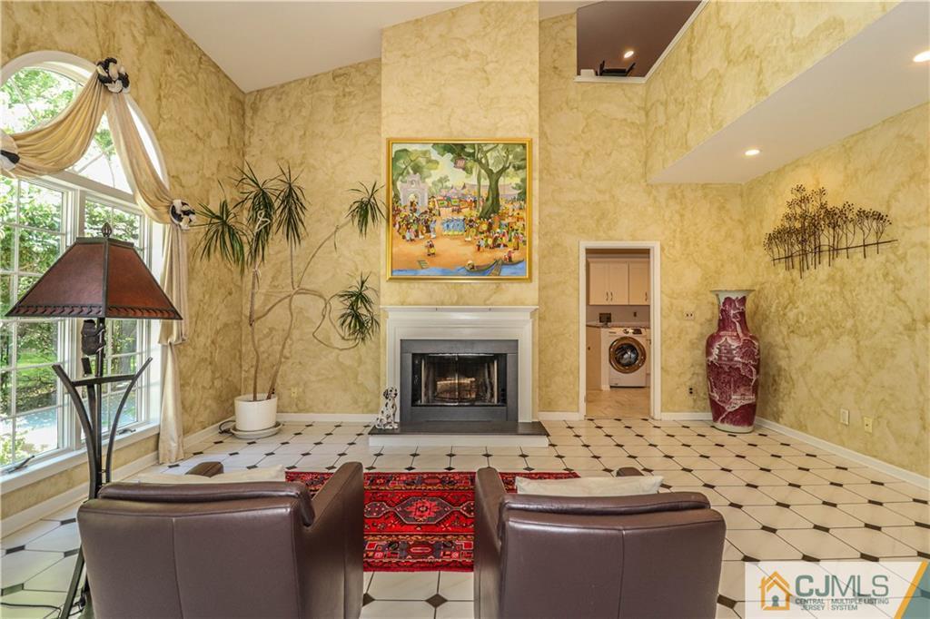 4 Southfield Road Edison, NJ 08820 - Photo 15 of 46 a living room with a couch and a fireplace