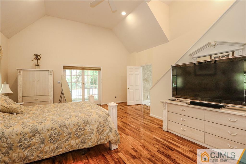 4 Southfield Road Edison, NJ 08820 - Photo 27 of 46 a bedroom with a flat screen tv on dresser and a window