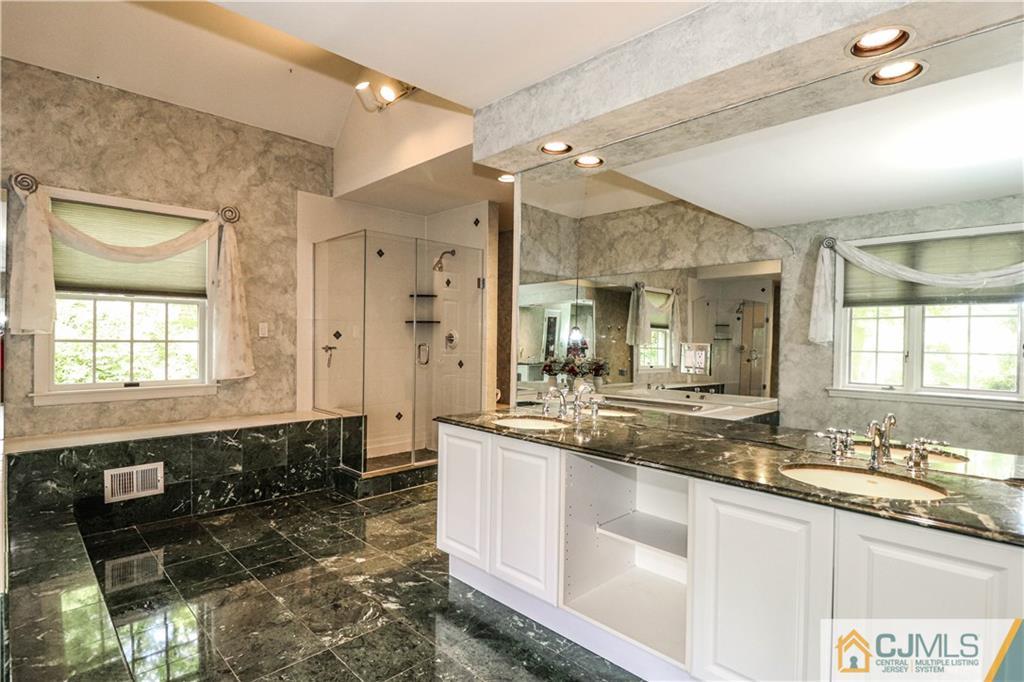 4 Southfield Road Edison, NJ 08820 - Photo 29 of 46 a large bathroom with a double vanity sink and a mirror