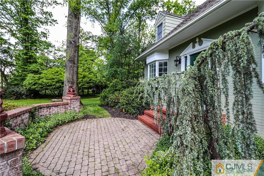 4 Southfield Road Edison, NJ 08820 - Photo 4 of 46 a view of a pathway with a yard