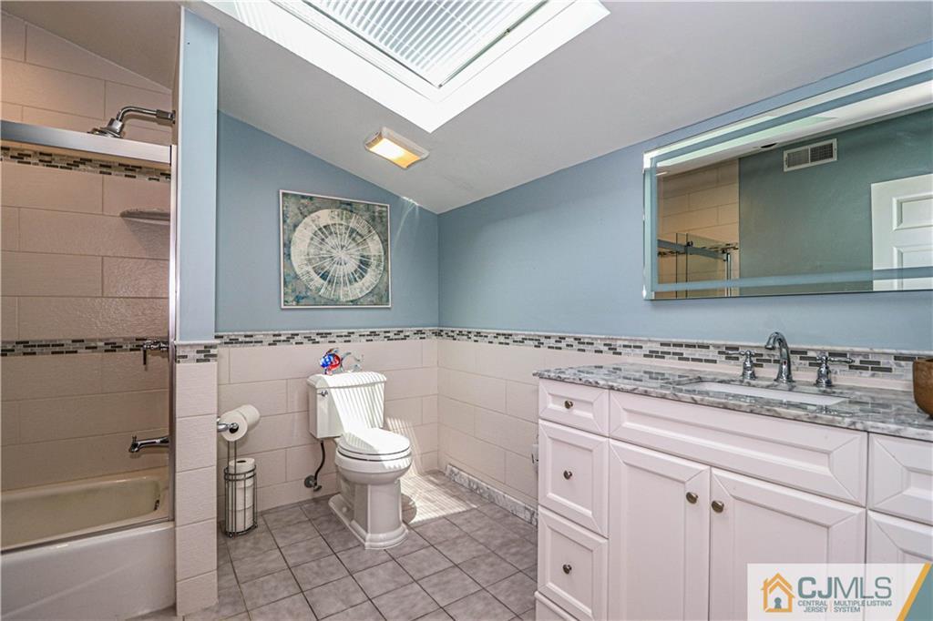 4 Southfield Road Edison, NJ 08820 - Photo 33 of 46 a bathroom with a granite countertop sink a toilet and a bathtub