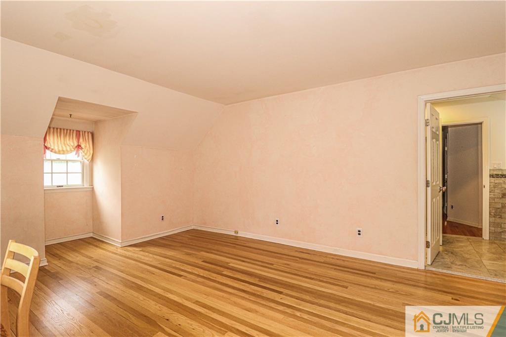 4 Southfield Road Edison, NJ 08820 - Photo 36 of 46 an empty room with wooden floor and windows