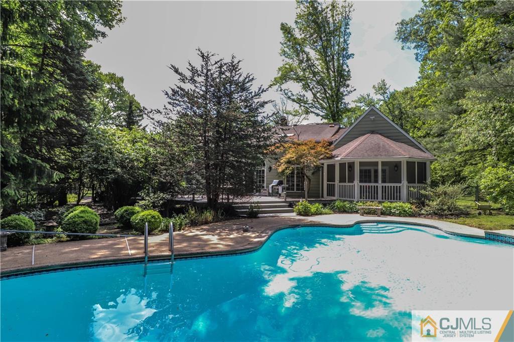 4 Southfield Road Edison, NJ 08820 - Photo 42 of 46 a front view of a house with swimming pool and yard