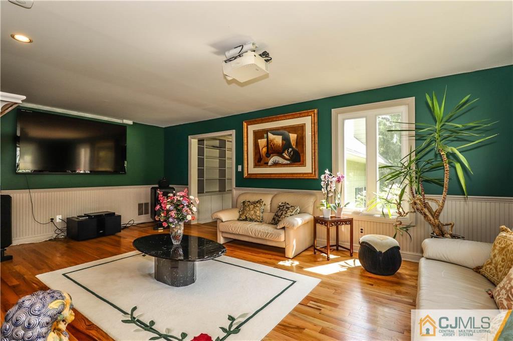 4 Southfield Road Edison, NJ 08820 - Photo 10 of 46 a living room with furniture and a flat screen tv
