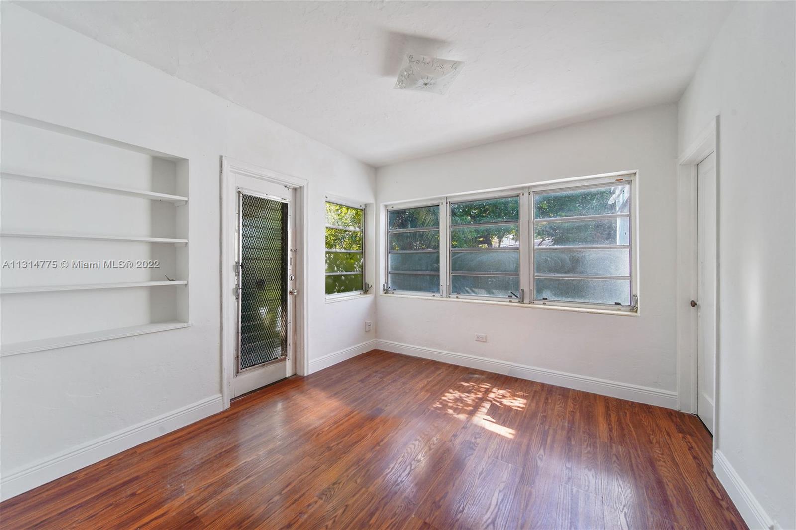 9116 Abbott Avenue Surfside, FL 33154 - Photo 11 of 23 a view of empty room with wooden floor and fan