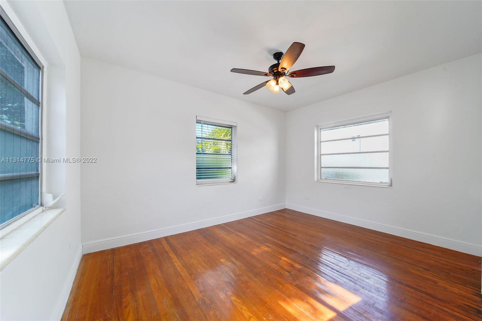 9116 Abbott Avenue Surfside, FL 33154 - Photo 13 of 23 a view of a room with a window and wooden floor