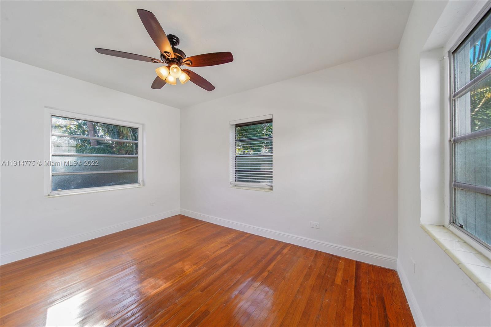 9116 Abbott Avenue Surfside, FL 33154 - Photo 14 of 23 a view of empty room with wooden floor and fan