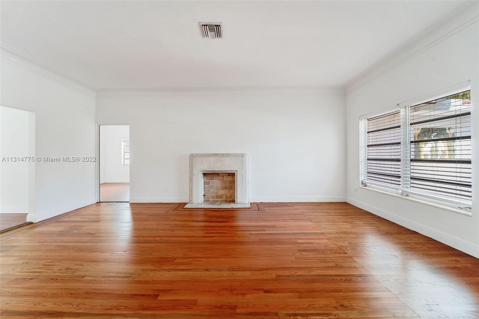 9116 Abbott Avenue Surfside, FL 33154 - Photo 4 of 23 a view of an empty room with window and wooden floor