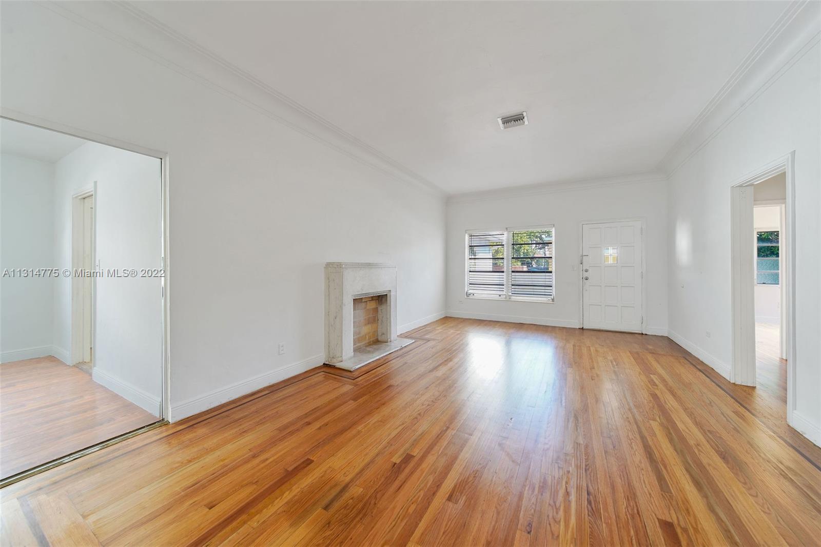 9116 Abbott Avenue Surfside, FL 33154 - Photo 5 of 23 an empty room with wooden floor and windows