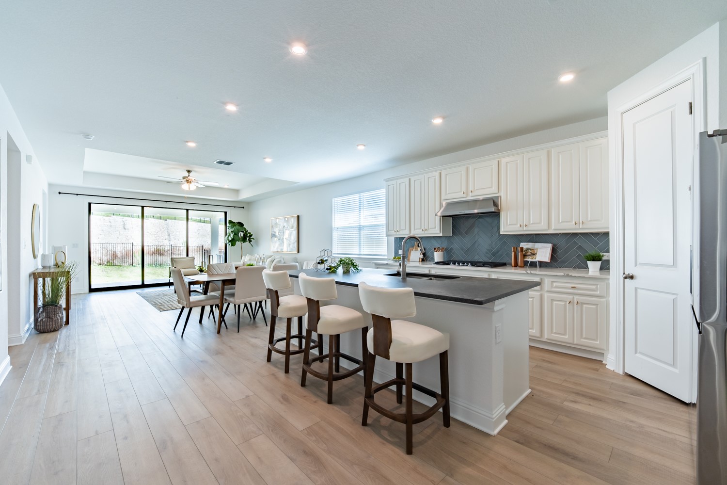 1040 Villa Rialto View Leander, TX 78641 - Photo 3 of 24 An open concept design seamlessly connects the kitchen to a bright dining area, featuring a spacious island and modern appliances.