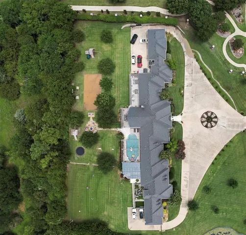 an aerial view of a house with outdoor space and a lake view